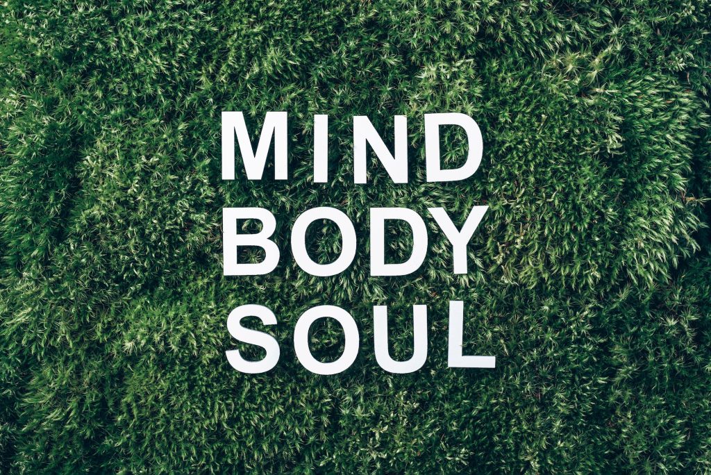 Words Body, mind, spirit and soul on moss, green grass background. Work Life Balance concept